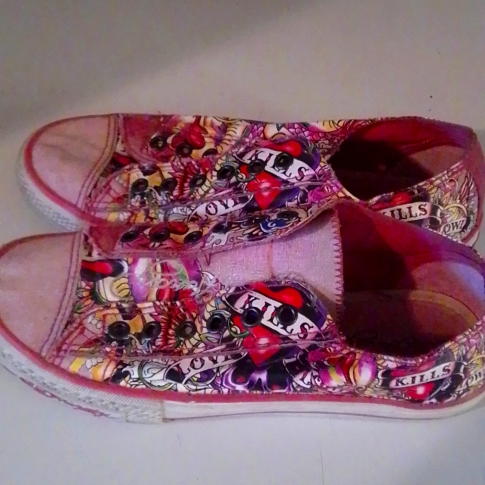 A pair of women's size 7 Love kills slowly tennis shoes used but in good shape.